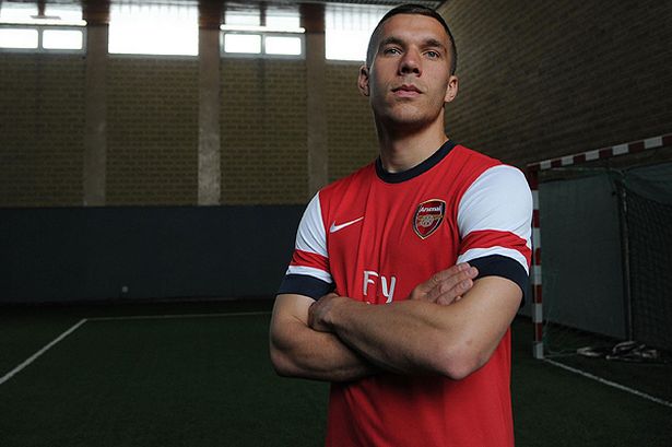 New+Arsenal+signing+Lukas+Podolski+poses+in+his+new+kit