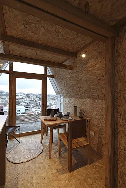 a-small-dining-table-is-situated-near-the-front-door-for-city-views-during-breakfast-or-dinner.jpg