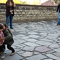 Carolina playing with another kid at Golden Lane, Prague Castle