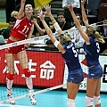 Gamova (left) of Russia spikes against Anzanello and Togut (ITA)