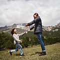 woman-and-child-playing-on-green-grass-field-near-mountain-2495566.jpg