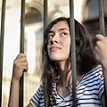 sad-isolated-young-woman-looking-away-through-fence-with-3808803.jpg